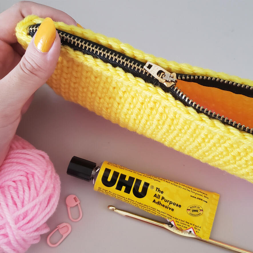 Pouch with glued zipper